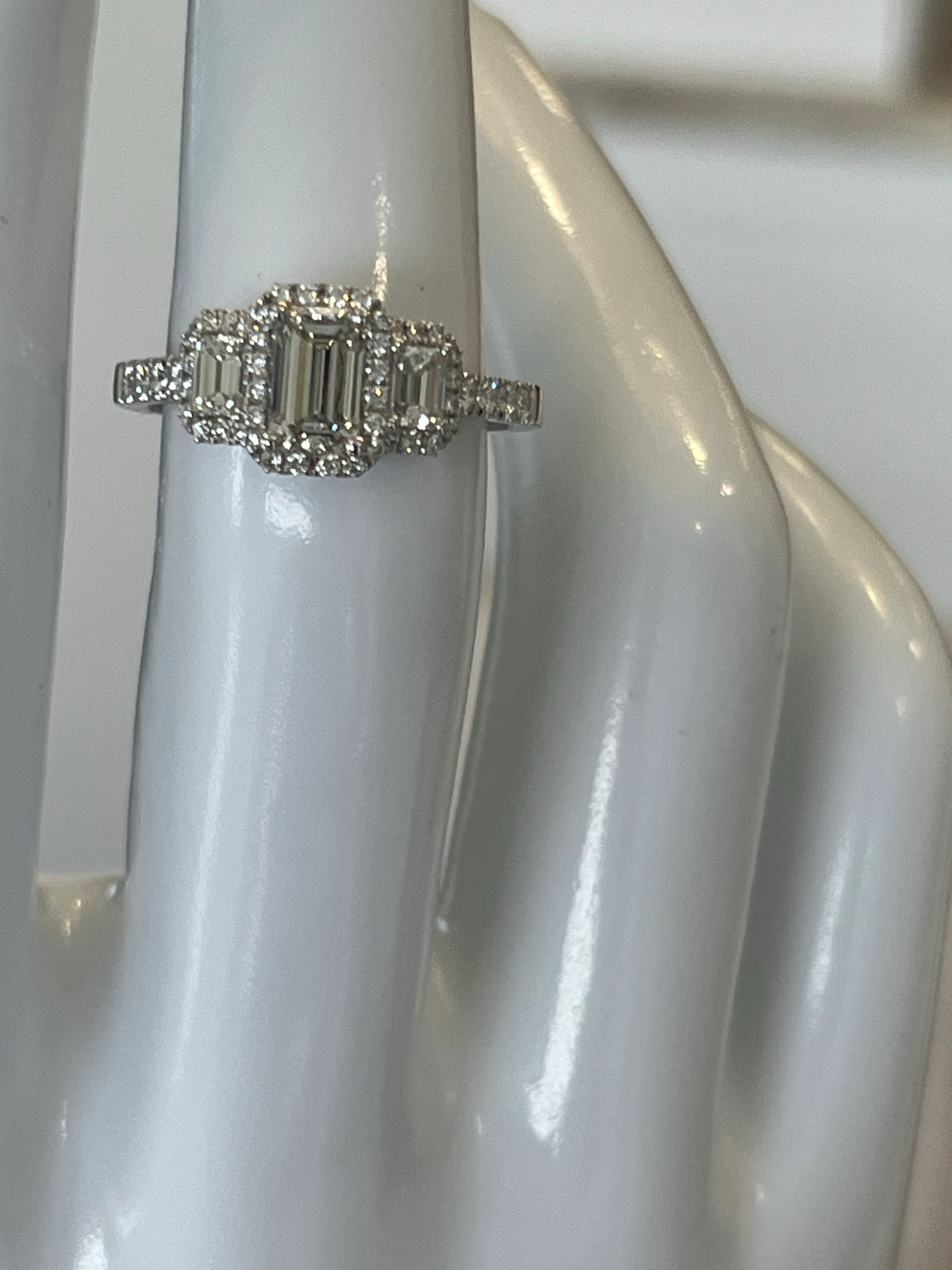 14K White Gold Three-Stone Halo Ring Featuring a .65ct J VS1 Emerald-Cut Diamond with .59ctw Diamond Accents