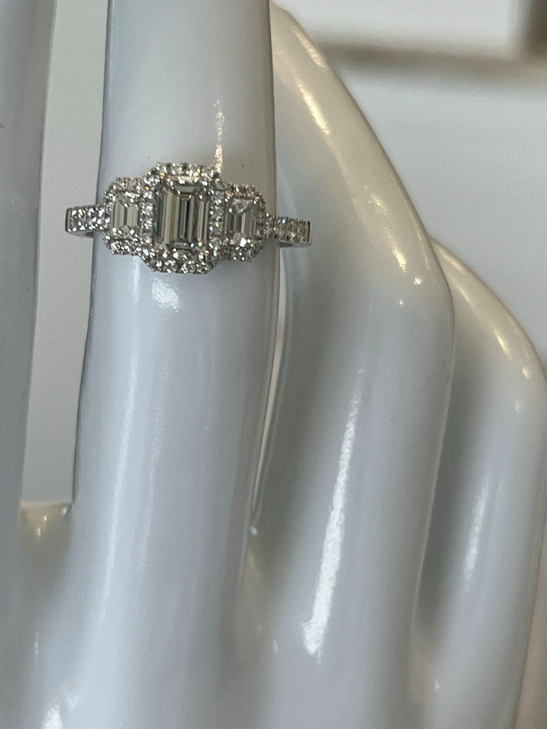 14K White Gold Three-Stone Halo Ring Featuring a .65ct J VS1 Emerald-Cut Diamond with .59ctw Diamond Accents
