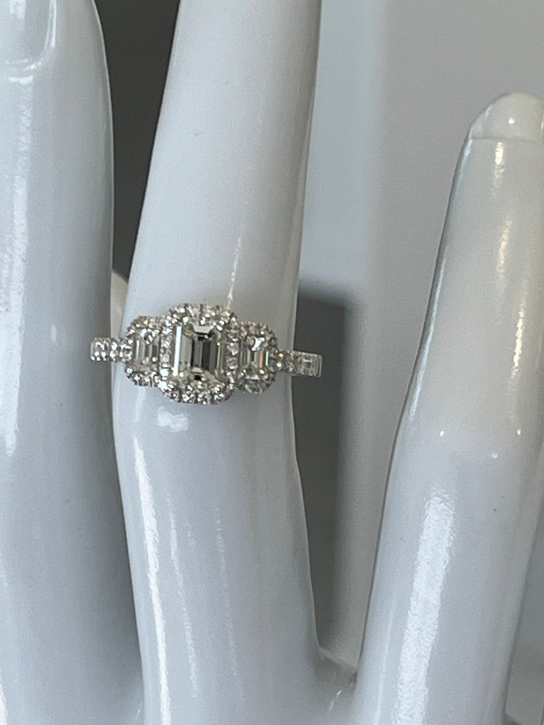 14K White Gold Three-Stone Halo Engagement Ring Featuring a .86ct J SI2 Emerald-Cut Diamond with .59ctw Diamond Accents