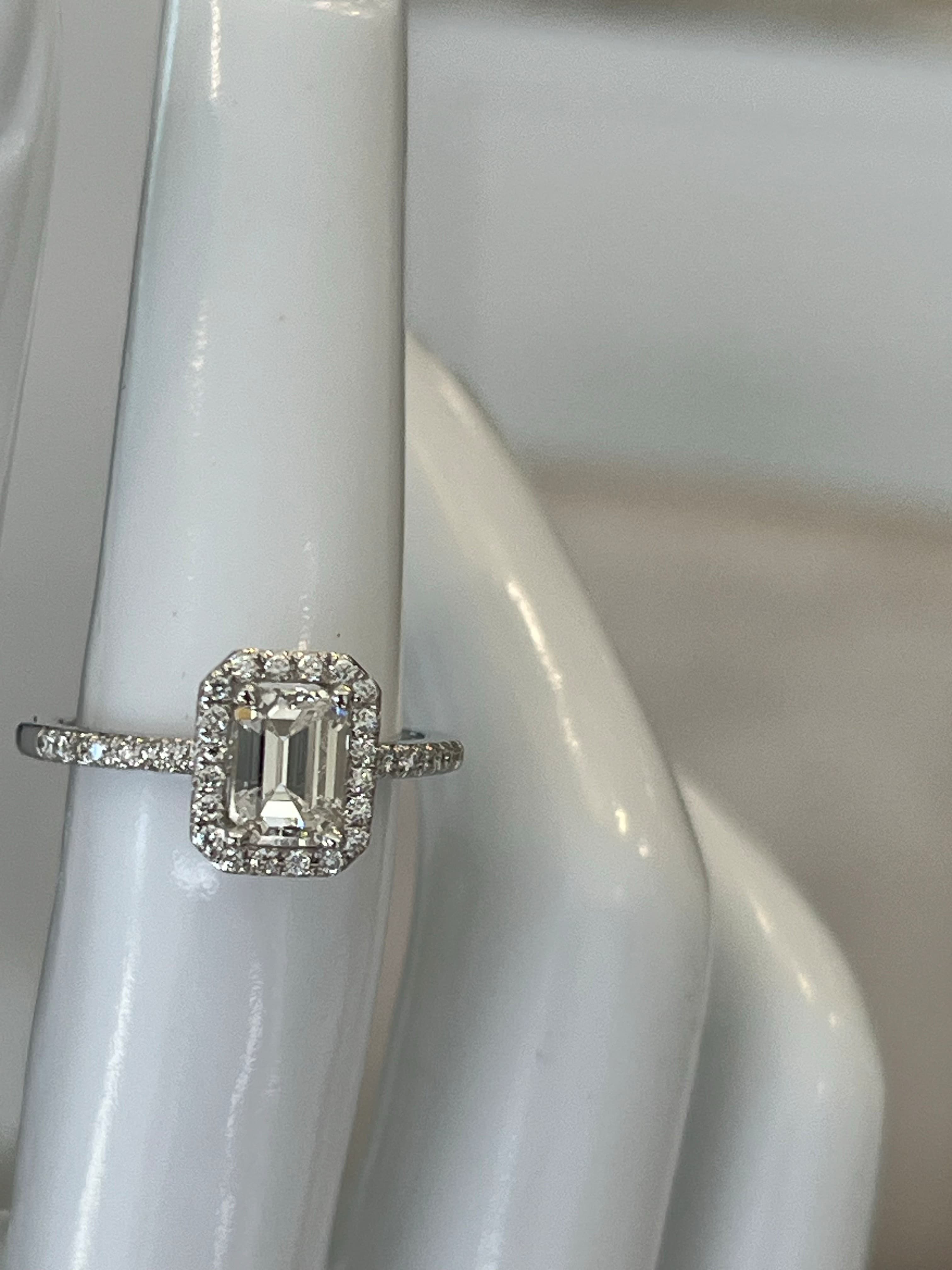 14K White Gold Halo Ring Featuring a 1.00ct H SI2 Emerald-Cut Diamond with .26ctw Diamond Accents
