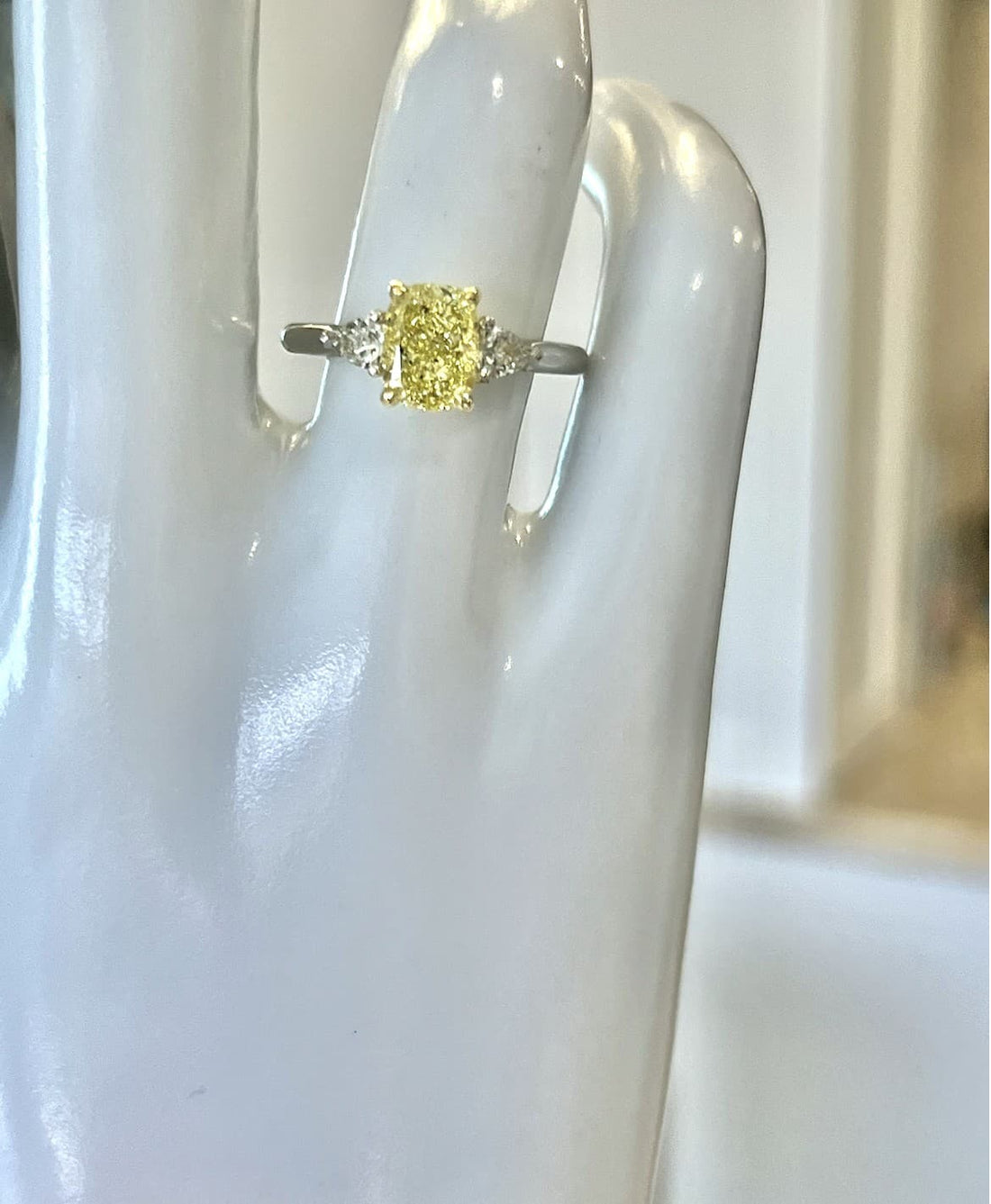 Platinum and 18K Yellow Gold Three-Stone Ring Featuring a 1.62ct GIA-Certified Fancy Light Yellow Cushion-Cut Diamond with .36ctw Trilliant-Cut Diamond Accents