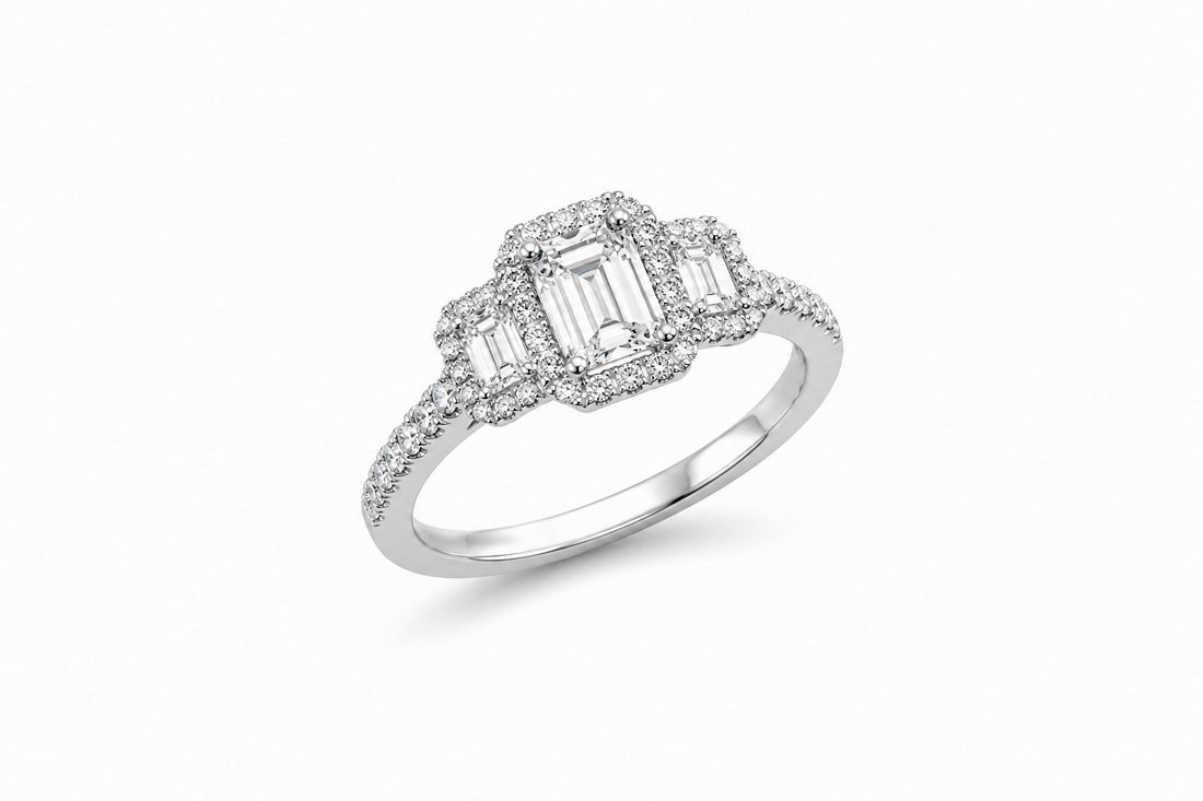 14K White Gold Three-Stone Halo Ring Featuring a .65ct J VS1 Emerald-Cut Diamond with .59ctw Diamond Accents engagement