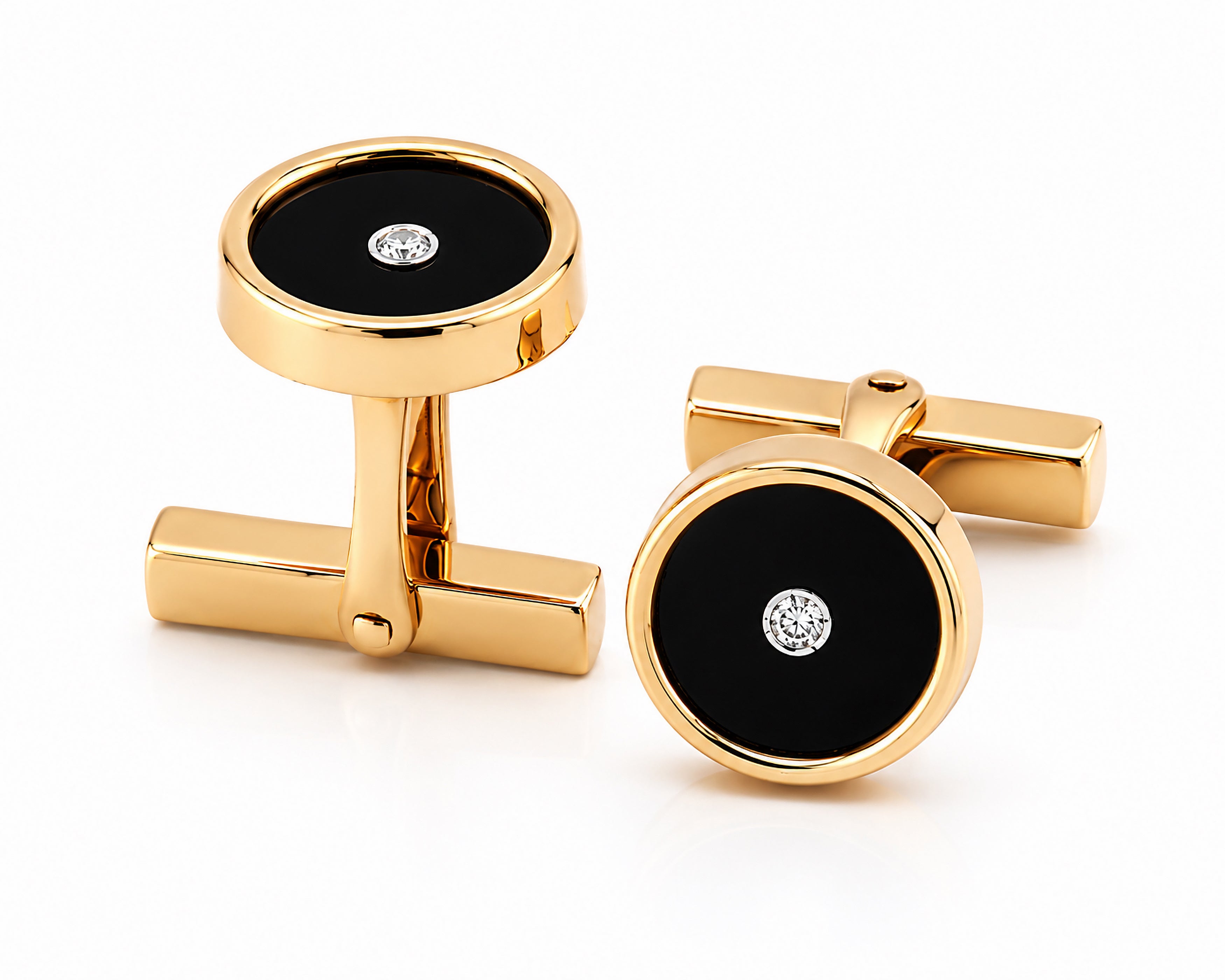 Gold cufflinks with black circular centers and diamonds on a white background. Tiffany & Co.