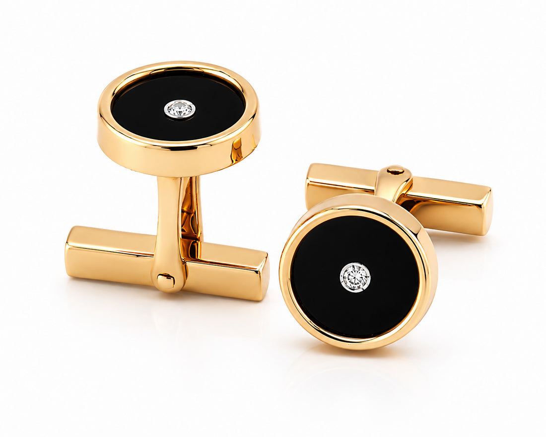 Gold cufflinks with black circular centers and diamonds on a white background. Tiffany & Co.
