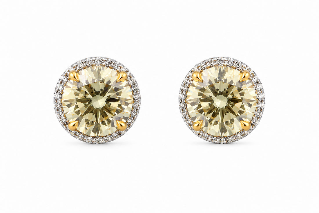 Pair of round yellow gemstone earrings with silver halos on a white background. 14K Gold Diamond Earrings Featuring a 2.09ct GIA-Certified Fancy Yellow VS2 Round Brilliant Diamond, a 2.01ct Fancy Yellow SI2 Round Brilliant Diamond, and .23ctw White Diamonds