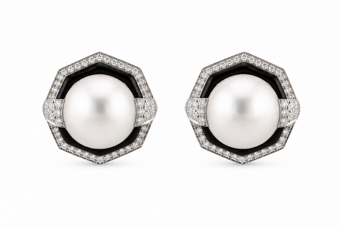 Pair of pearl earrings with black and white accents on a white background. David Webb